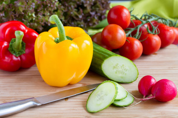 Cut vegetables, salad ingredients on wood board