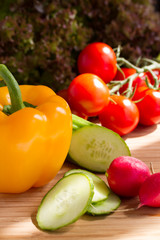 Cut vegetables, salad ingredients on wood board