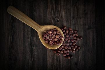Fresh hazelnuts on wooden spoon