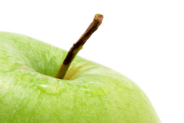 Close-up to single green apple isolated over white