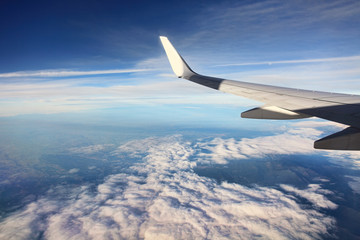 Fototapeta na wymiar Airplain over clouds.