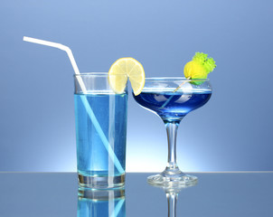 a variety of alcoholic drinks on blue background