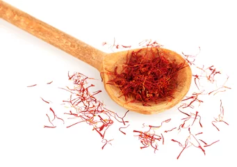 Poster stigmas of saffron in wooden spoon on white background close-up © Africa Studio