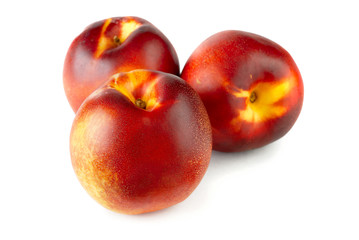 three nectarines on white background