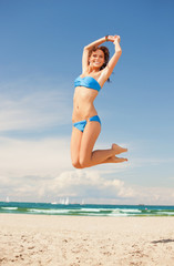 happy jumping woman on the beach