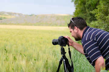 Photographer with  tripod and DSLR camera