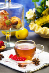 rooibos tea with confectionery over blue background