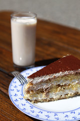 Ein Stück Tiramisutorte und Glas Buttermilch
