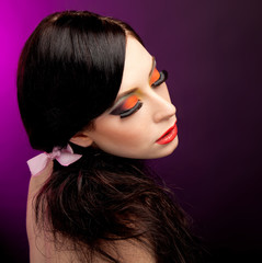Fototapeta premium Portrait of pretty young woman with bright colorful makeup