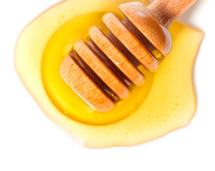 Honey flowing down from a wooden stick