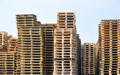 Huge piles of empty wooden pallets