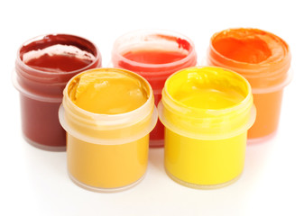 jars with multicolored gouache isolated on white background