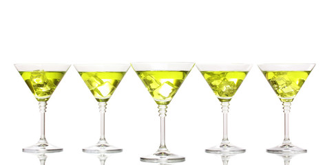 Yellow cocktail in martini glasses isolated on white