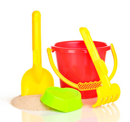 Children's beach toys and sand isolated on white