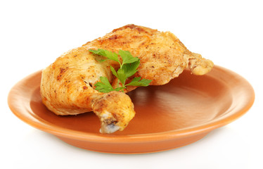roasted chicken leg with parsley in the plate isolated on white