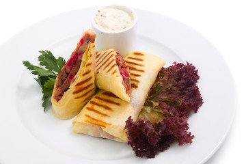 Roasted pancake with meat and greens on white