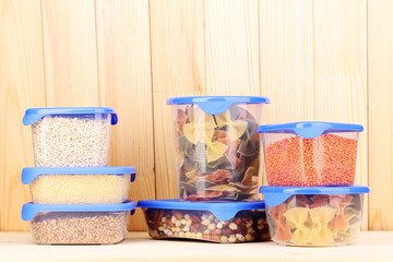 Filled plastic containers on wooden background