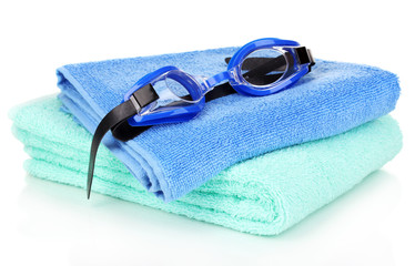 Swim goggles on towel isolated on white