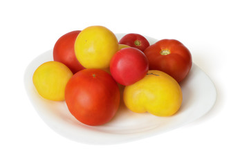 Red and yellow tomato on dish