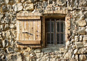 Vintage window in the ancient stone wall