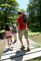 Back view of family walking on a bridge