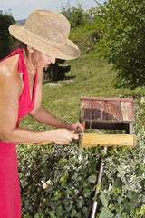 Woman repairing old bird house