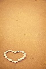 Fototapeta na wymiar Heart on sand
