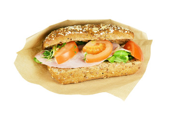 Brown sandwich with tomato, lettuce and mustard sauce.
