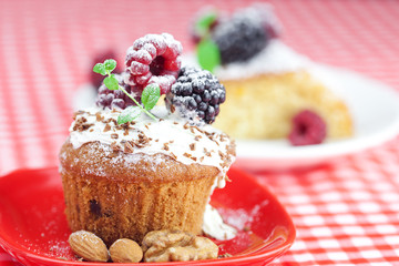 muffin with whipped cream, cake with icing, raspberry, blackberr