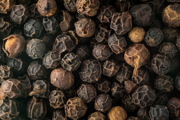 Macro photo of black peppercorn seeds