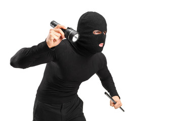 A thief holding a flashlight and piece of pipe