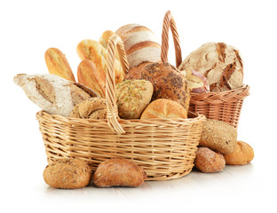 Bread and rolls in wicker baskets isolated on white