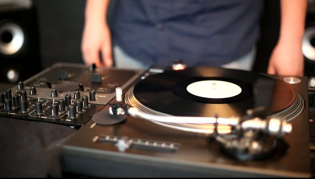 DJ spinning, mixing and scratching 