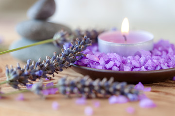 Obraz na płótnie Canvas Candle in a saucer with salt baths and sprigs of lavender