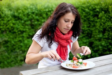 Woman Busy Eating by Herself