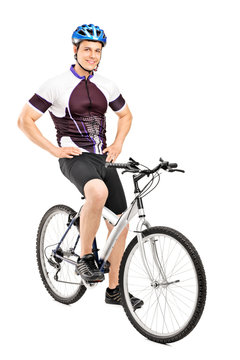 Full length portrait of a smiling bicyclist posing on a bicycle
