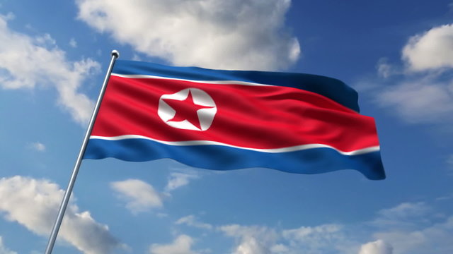 the North Korean flag waving against clouds background