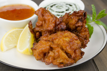 Onion Bhajis, mint raita, chili sauce, lemon  & mint leaves