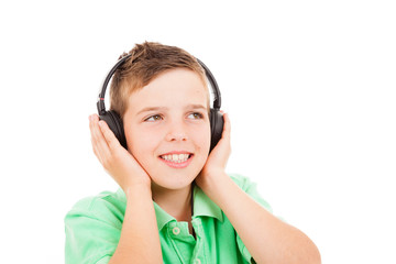 Fototapeta premium Young casual boy listening to music on headphones against white