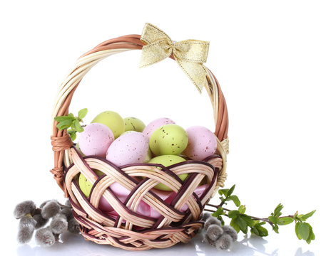 basket with Easter eggs and pussy-willow twigs isolated on