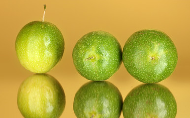 green passion fruit on yellow background close-up