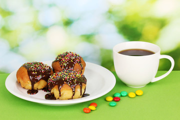 Appetizing cupcakes with chocolate on nature background
