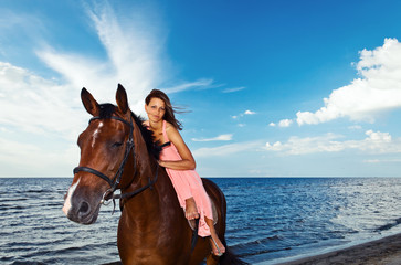 Obraz premium beautiful girl with horse on seacoast