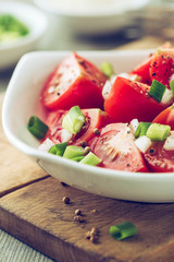 Tomato salad with spring onion and coriander seeds