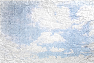Cloudy blue sky on textured vintage  paper effect