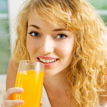Happy woman drinking juice