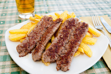 Grilled sausages on french fries