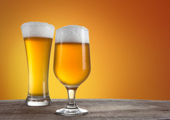 Beer in a glasses with gold background