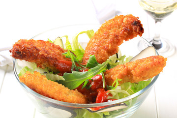 Crispy chicken tenders with salad