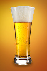 Beer in a glass with gold background
